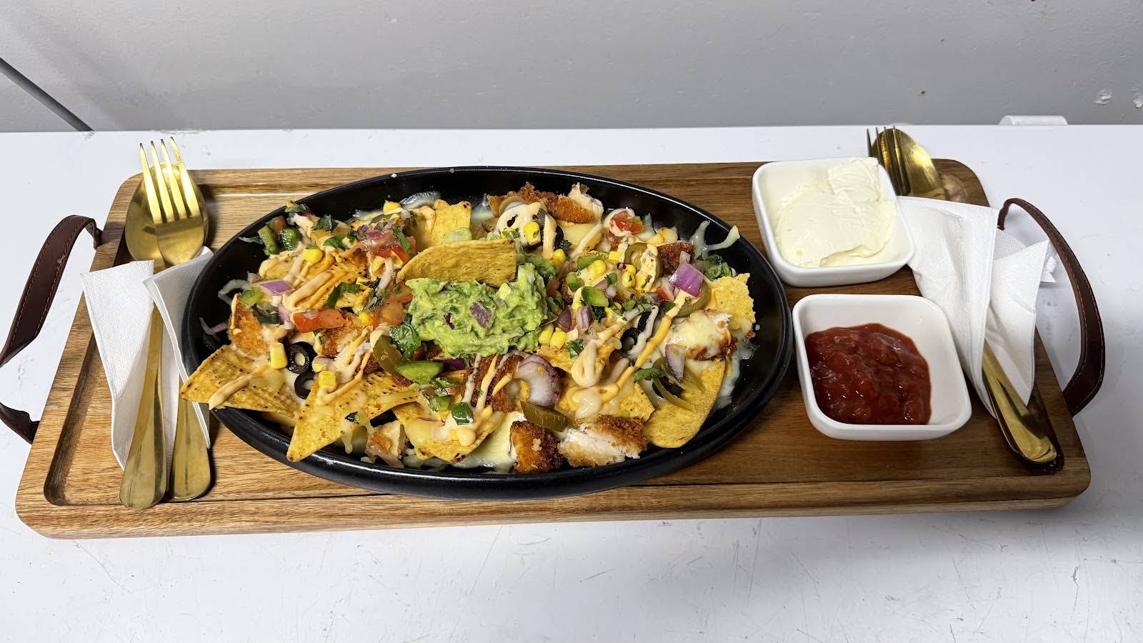 Illumina loaded nachos served with guacamole, sour cream and salsa