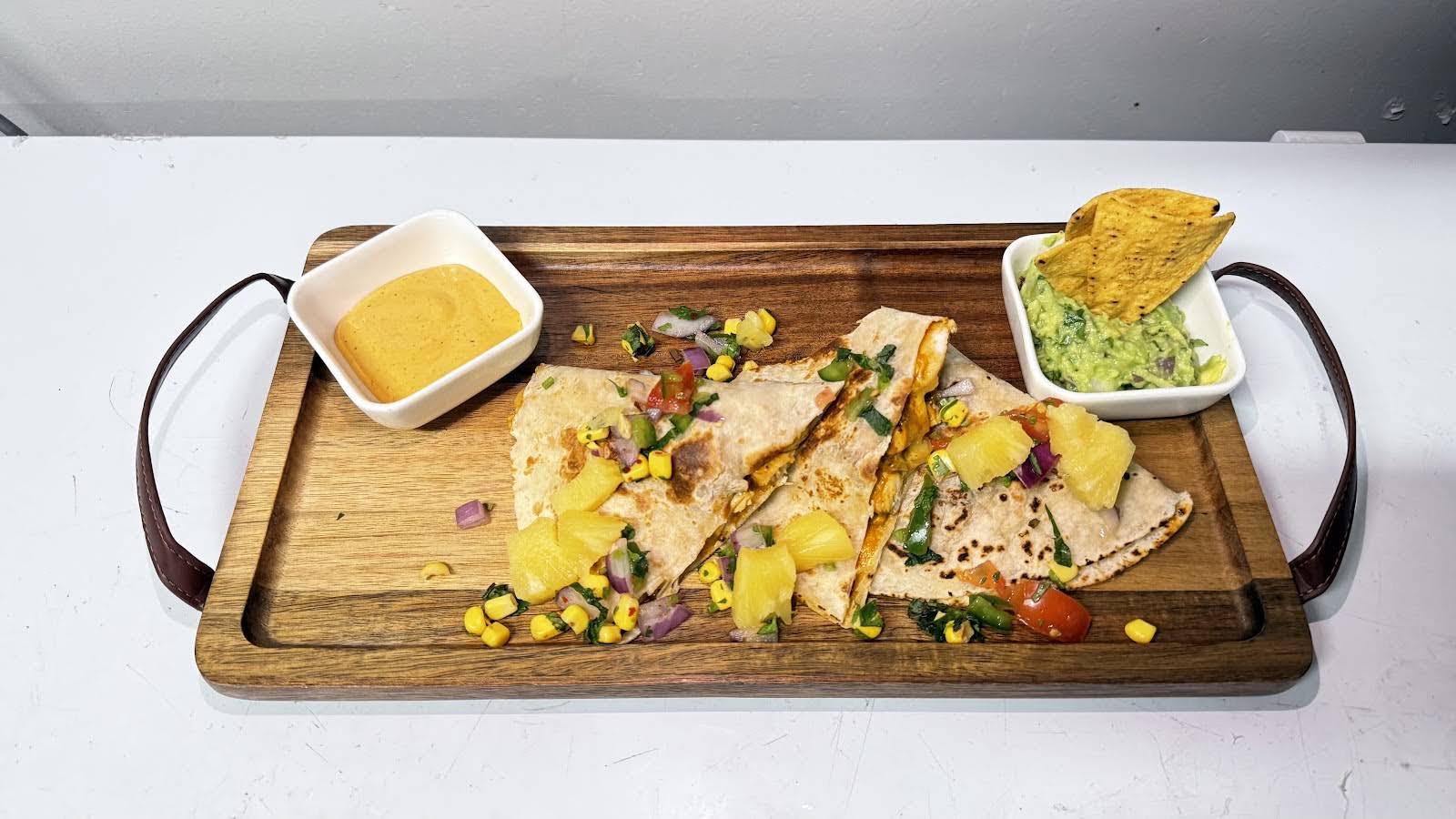 Illumina quesadilla served with guacamole, salsa and corn salad