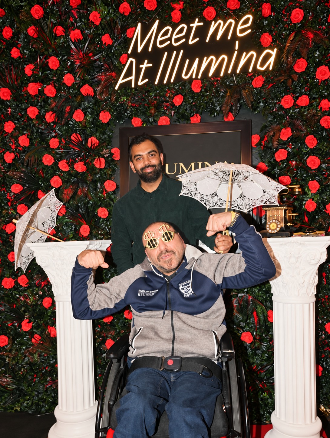 Guests posing at Illumina's signature rose-wall photo spot